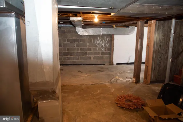 a view of room with wooden floor and flat screen tv