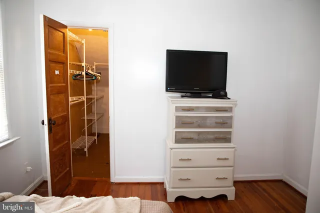 a view of a hallway with closet and a bathroom
