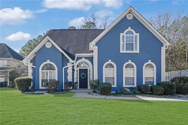 a front view of a house with garden