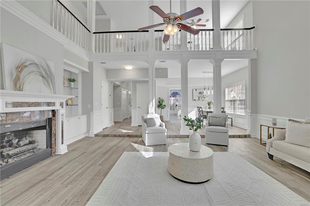 5696 Kilrush Court Mableton, GA 30126 - Photo 11 of 46 a living room with furniture a fireplace and a chandelier