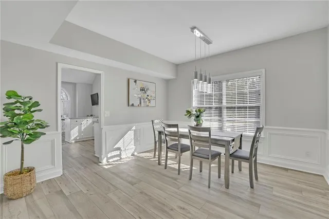 a view of a dining room with furniture and wooden floor