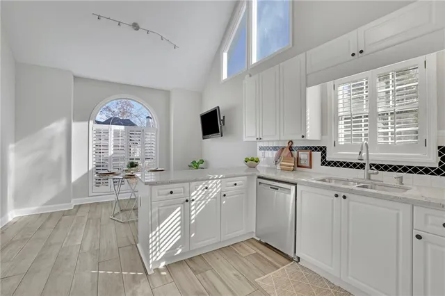 a large white kitchen with a window