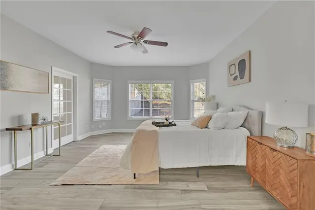 a living room with a bed furniture and a large window