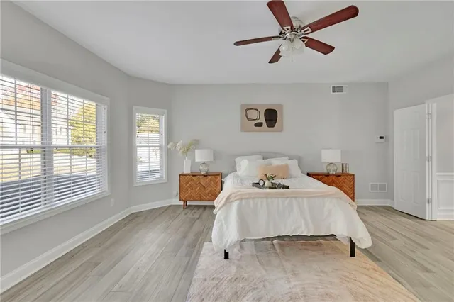a bedroom with a bed and wooden floor