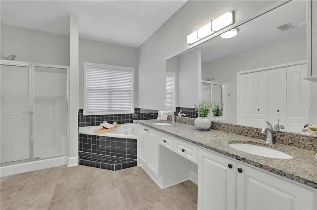 5696 Kilrush Court Mableton, GA 30126 - Photo 24 of 46 a bathroom with a granite countertop double vanity sink and mirror