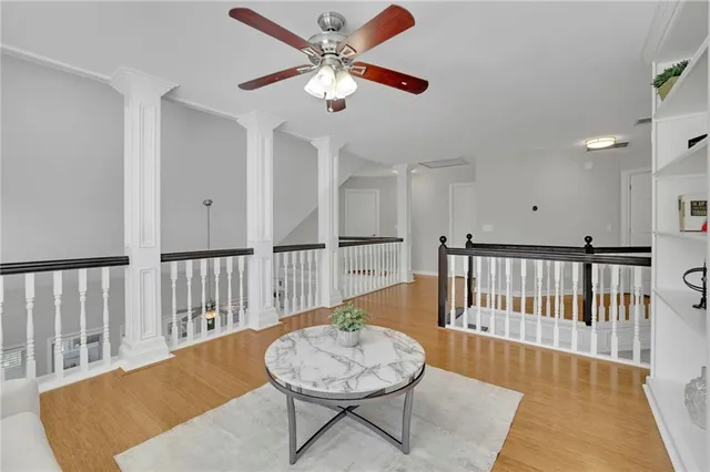 a living room with wooden floor and a table