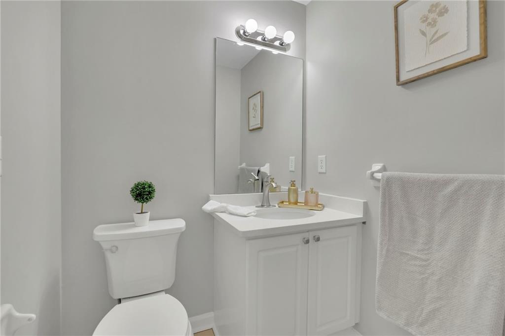 5696 Kilrush Court Mableton, GA 30126 - Photo 38 of 46 a bathroom with a toilet a sink and a mirror