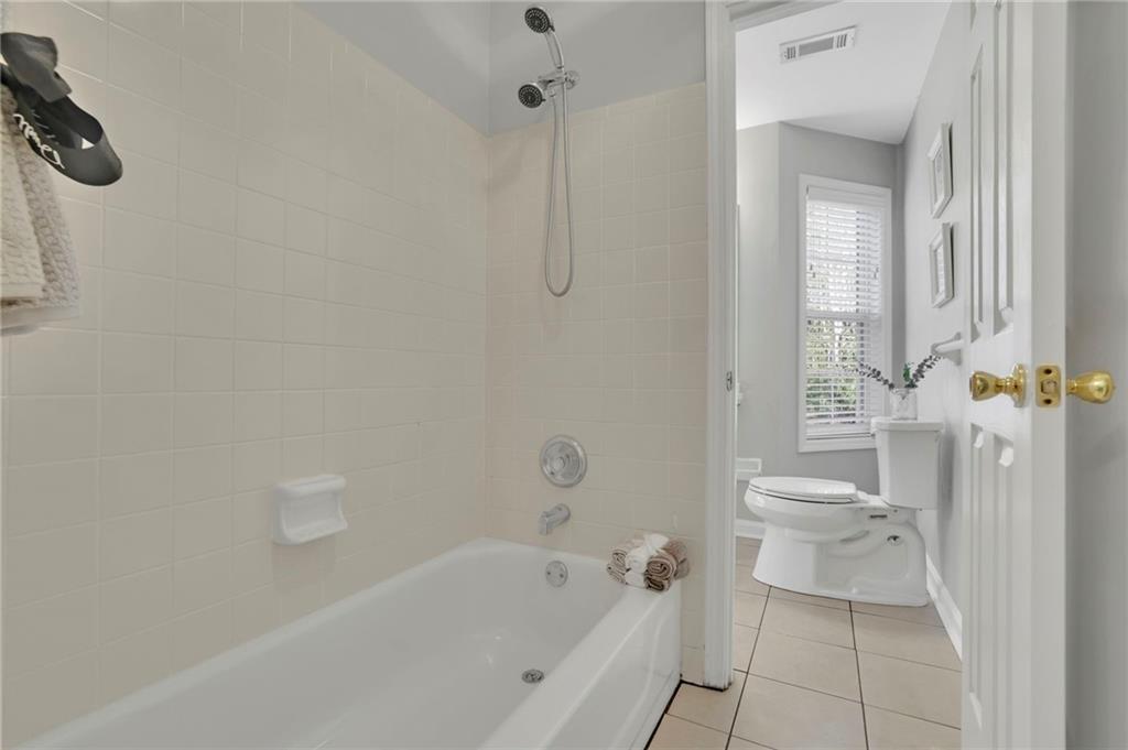 5696 Kilrush Court Mableton, GA 30126 - Photo 39 of 46 a bathroom with a bathtub a toilet and a shower