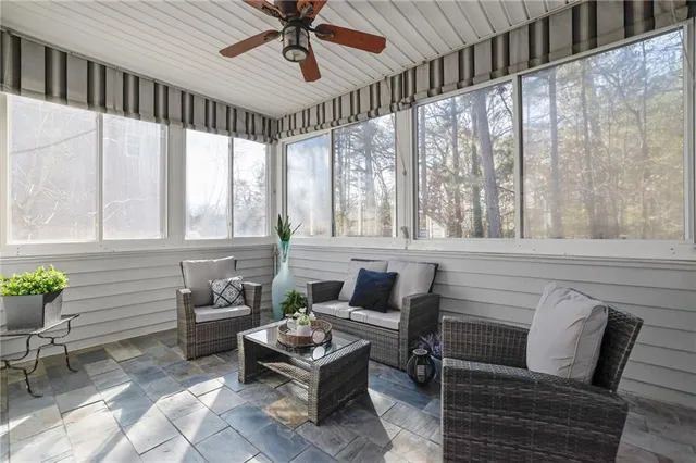 a living room with furniture and a large window