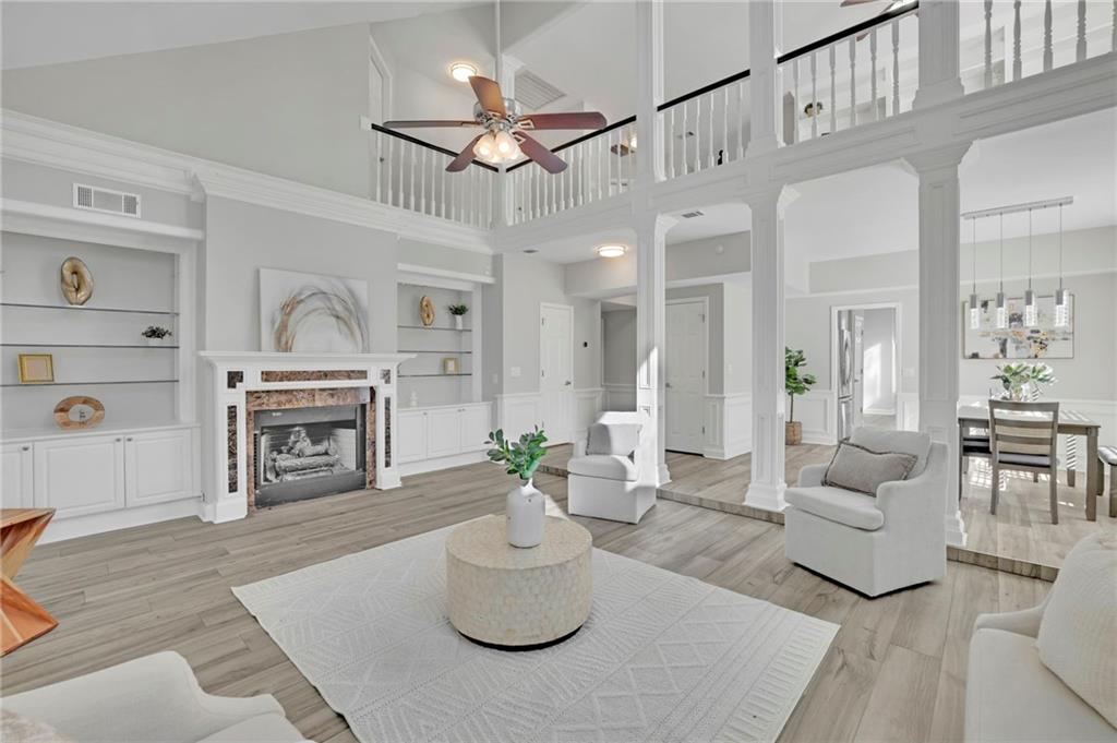 5696 Kilrush Court Mableton, GA 30126 - Photo 9 of 46 a living room with furniture a fireplace and a chandelier