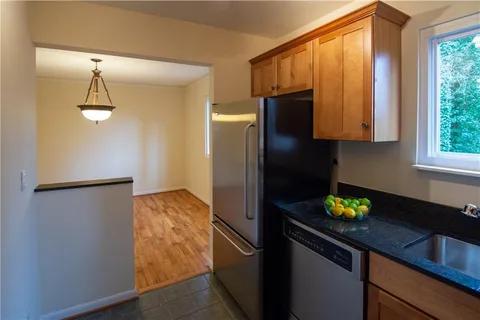 a kitchen with a refrigerator and a sink