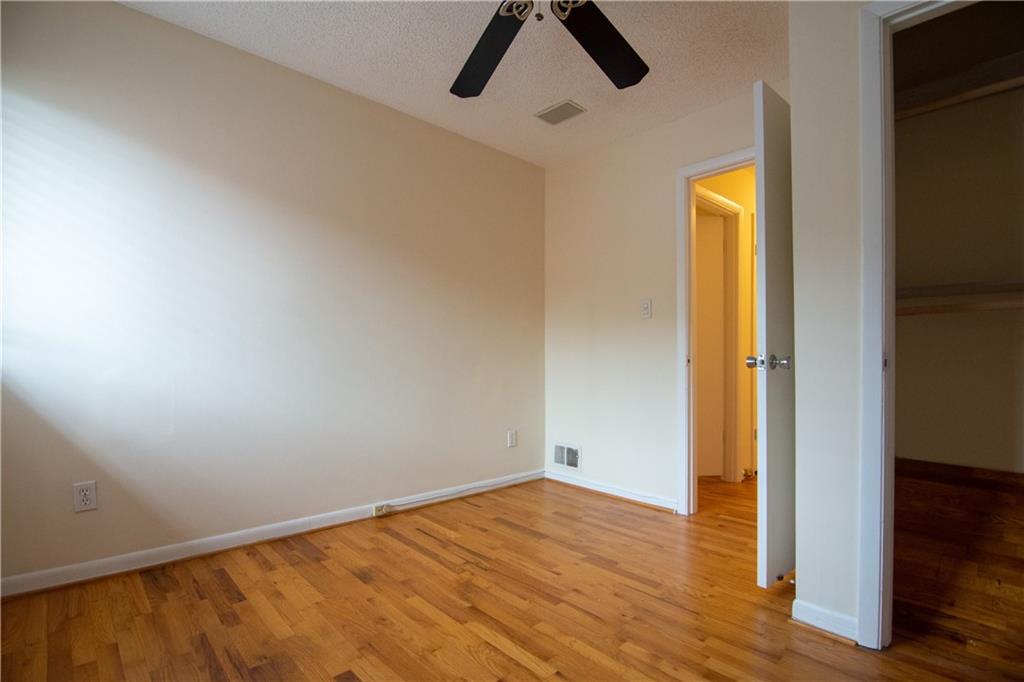 1612 Briarcliff Road Northeast, Unit 7 Atlanta, GA 30306 - Photo 20 of 29 an empty room with wooden floor and natural light