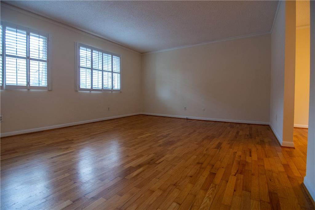 1612 Briarcliff Road Northeast, Unit 7 Atlanta, GA 30306 - Photo 2 of 29 an empty room with wooden floor and windows