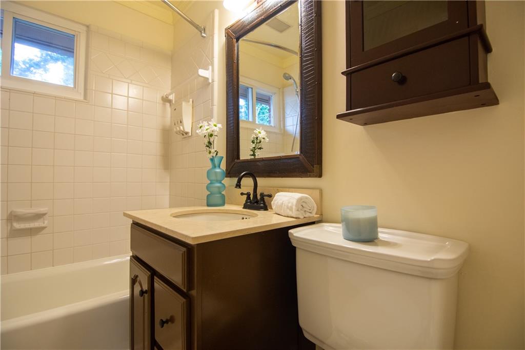 1612 Briarcliff Road Northeast, Unit 7 Atlanta, GA 30306 - Photo 23 of 29 a bathroom with a sink toilet and shower