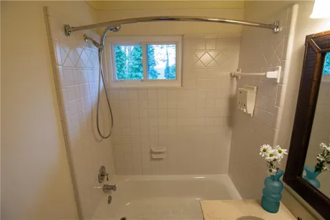 a bathroom with a shower and a shower