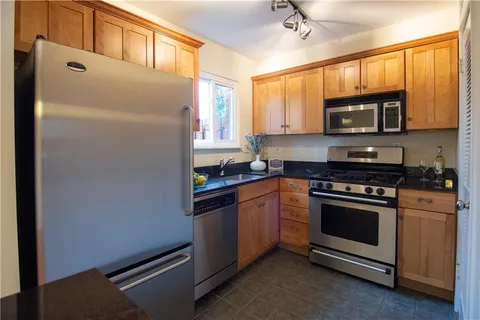 a kitchen with stainless steel appliances a stove a microwave and a sink
