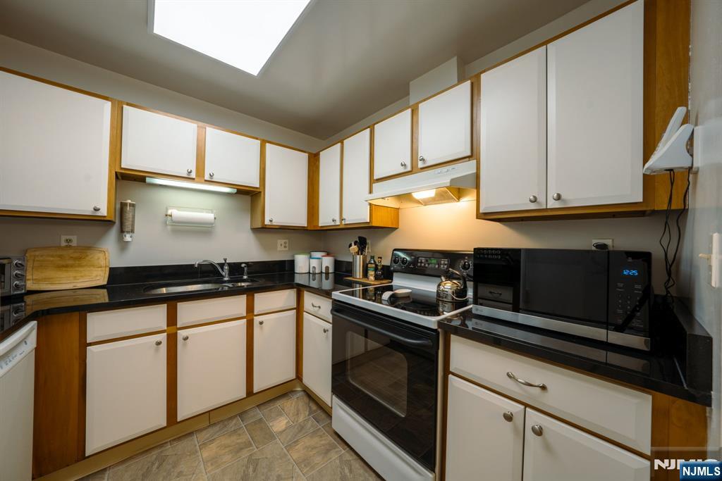 208 Federal Hill Road Pompton Lakes, NJ 07442 - Photo 4 of 22 a kitchen with granite countertop a sink cabinets and stainless steel appliances