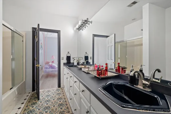 a bathroom with a double vanity sink mirror and double