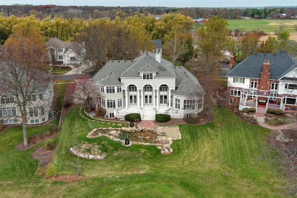 an aerial view of a house with a big yard