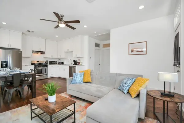 a living room with furniture and kitchen view