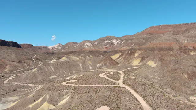 a view of a dry yard with mountains in the background