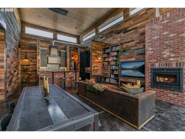 a living room with patio furniture and a fireplace