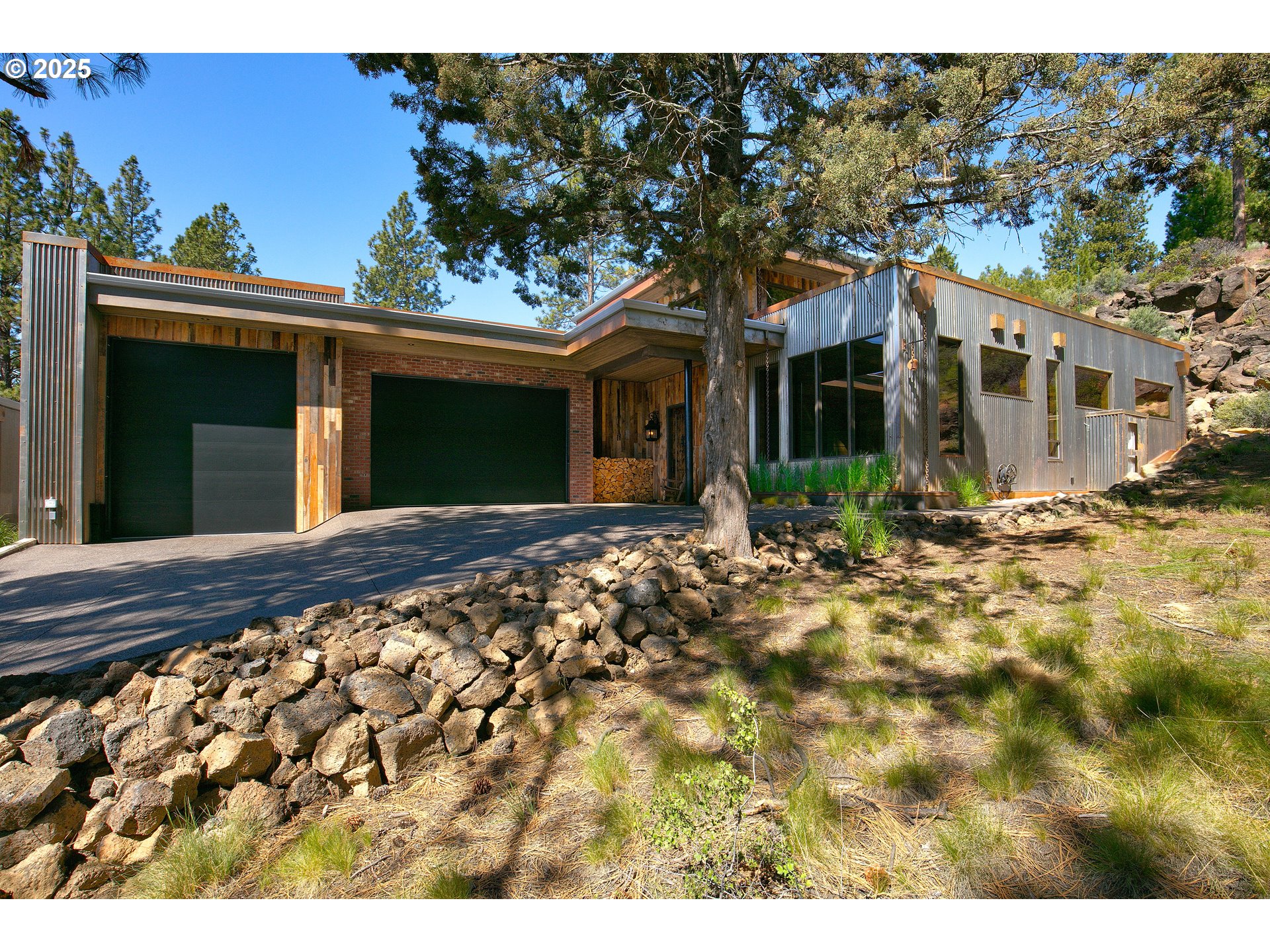 19476 Southwest Century Drive Bend, OR 97702 - Photo 2 of 44 a front view of a house with a yard