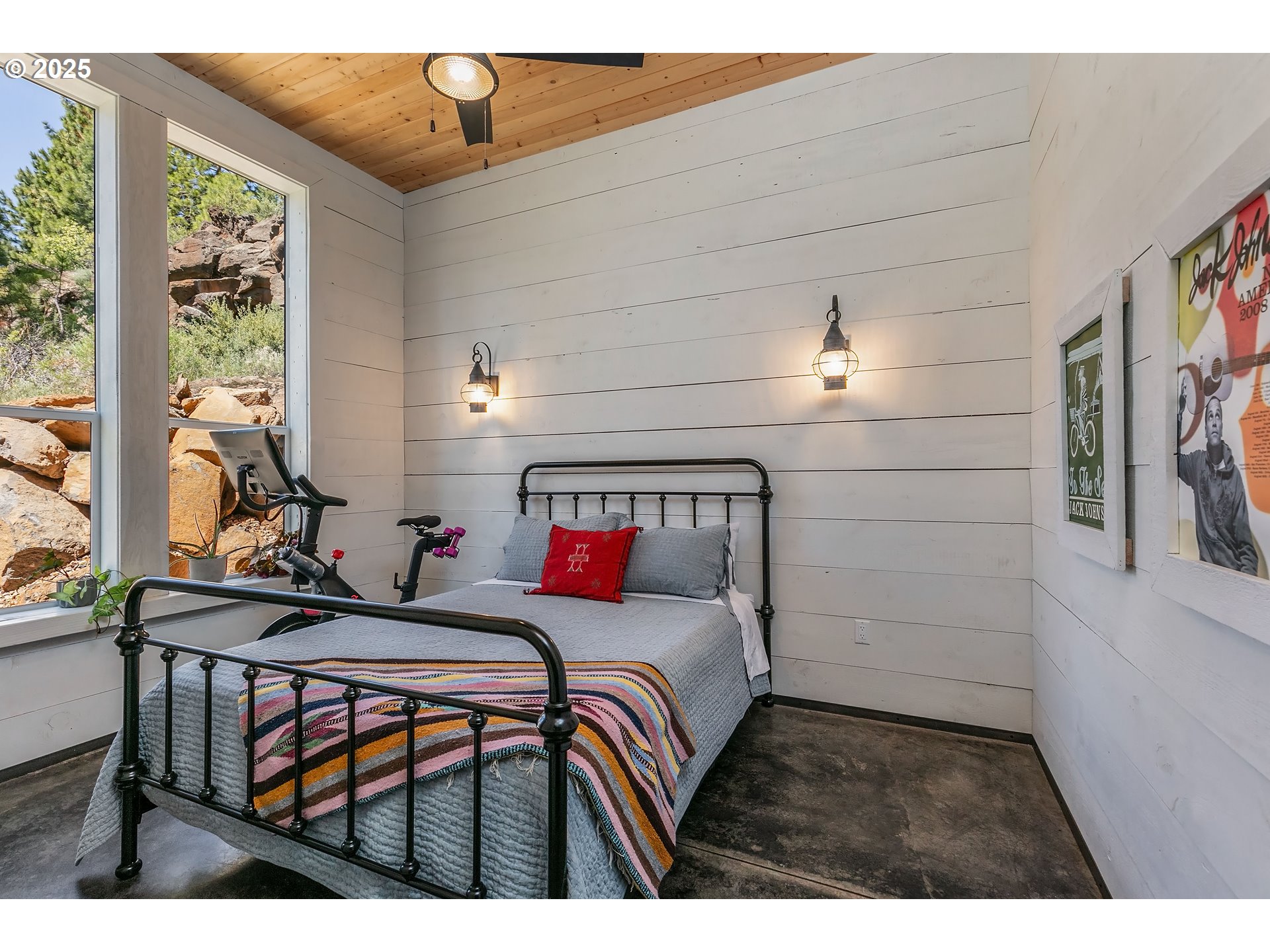 19476 Southwest Century Drive Bend, OR 97702 - Photo 27 of 44 a bedroom with a bed and a chandelier