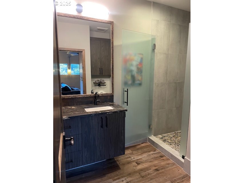 19476 Southwest Century Drive Bend, OR 97702 - Photo 40 of 44 a bathroom with a granite countertop sink and a mirror