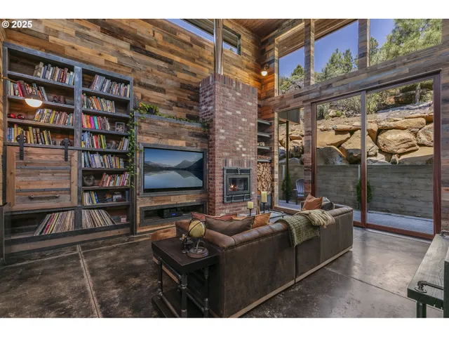 a living room with furniture a rug and a bookshelf