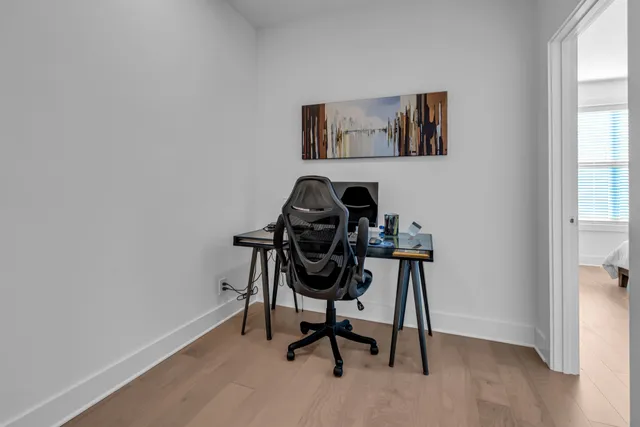 a view of a workspace with furniture and a window