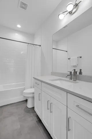 a bathroom with a sink a toilet and a bathtub