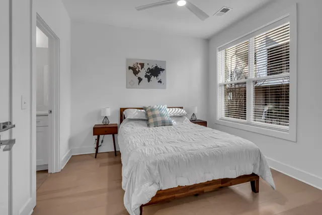 a bedroom with a bed and a window