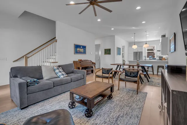 a living room with furniture and a view of kitchen