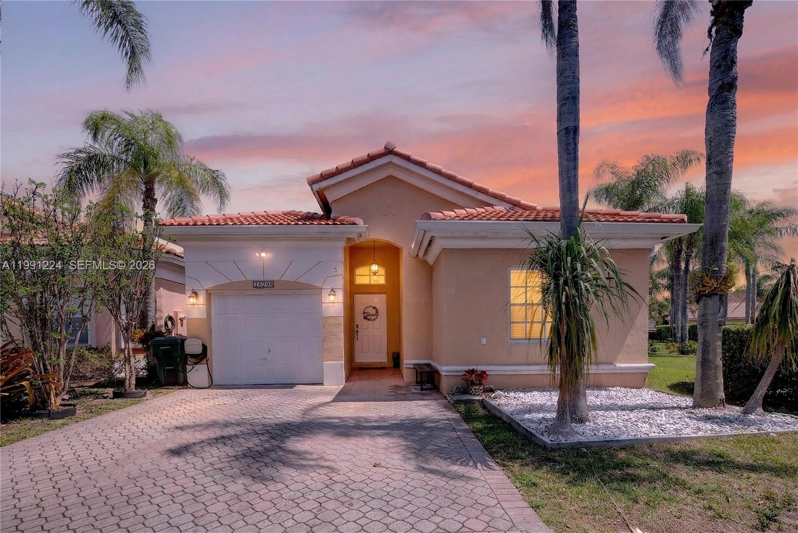 16299 Southwest 103rd Street Miami, FL 33196 - Photo 1 of 30 a front view of a house with a yard