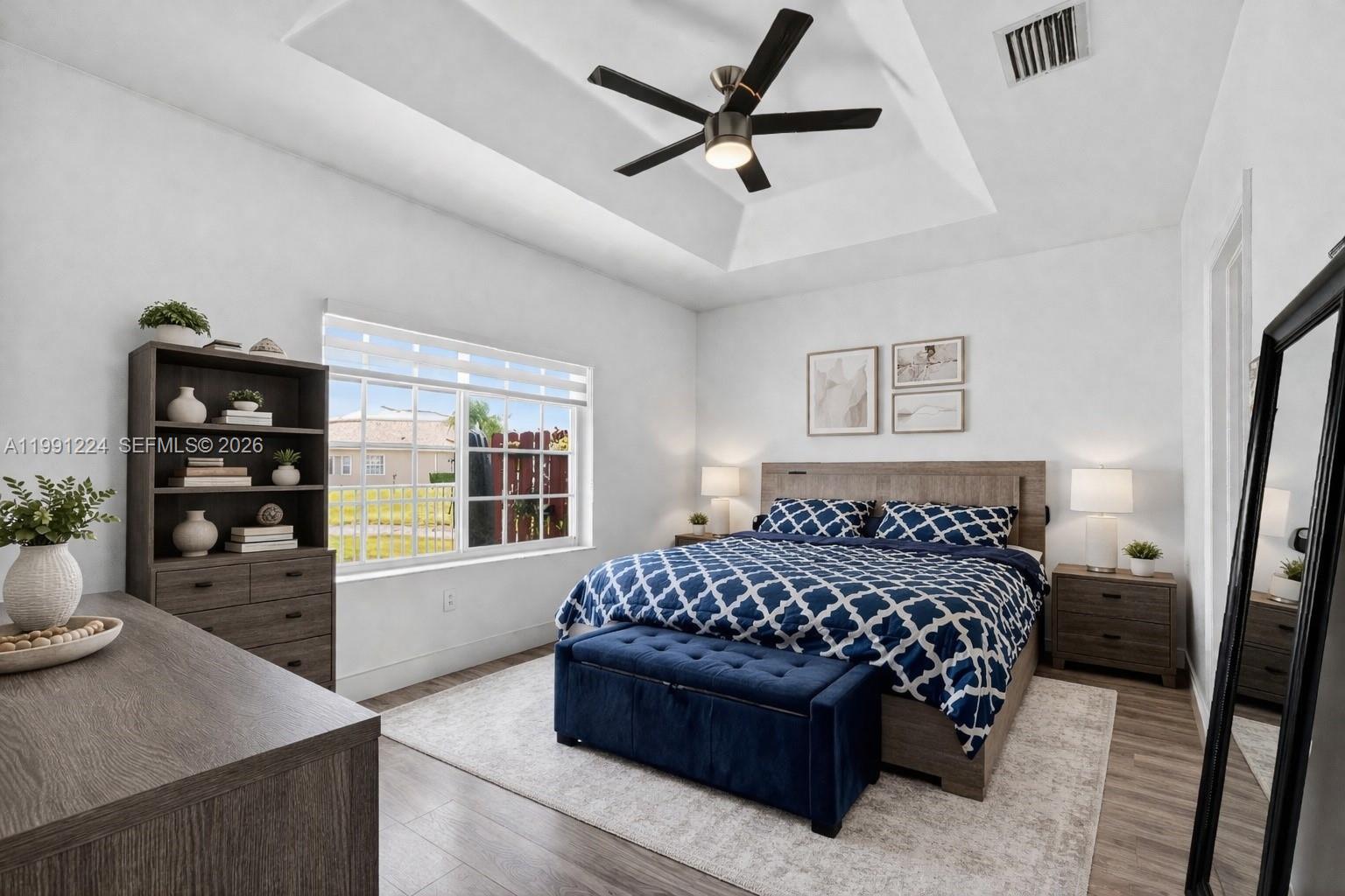 16299 Southwest 103rd Street Miami, FL 33196 - Photo 19 of 30 a bedroom with a bed couch and a window