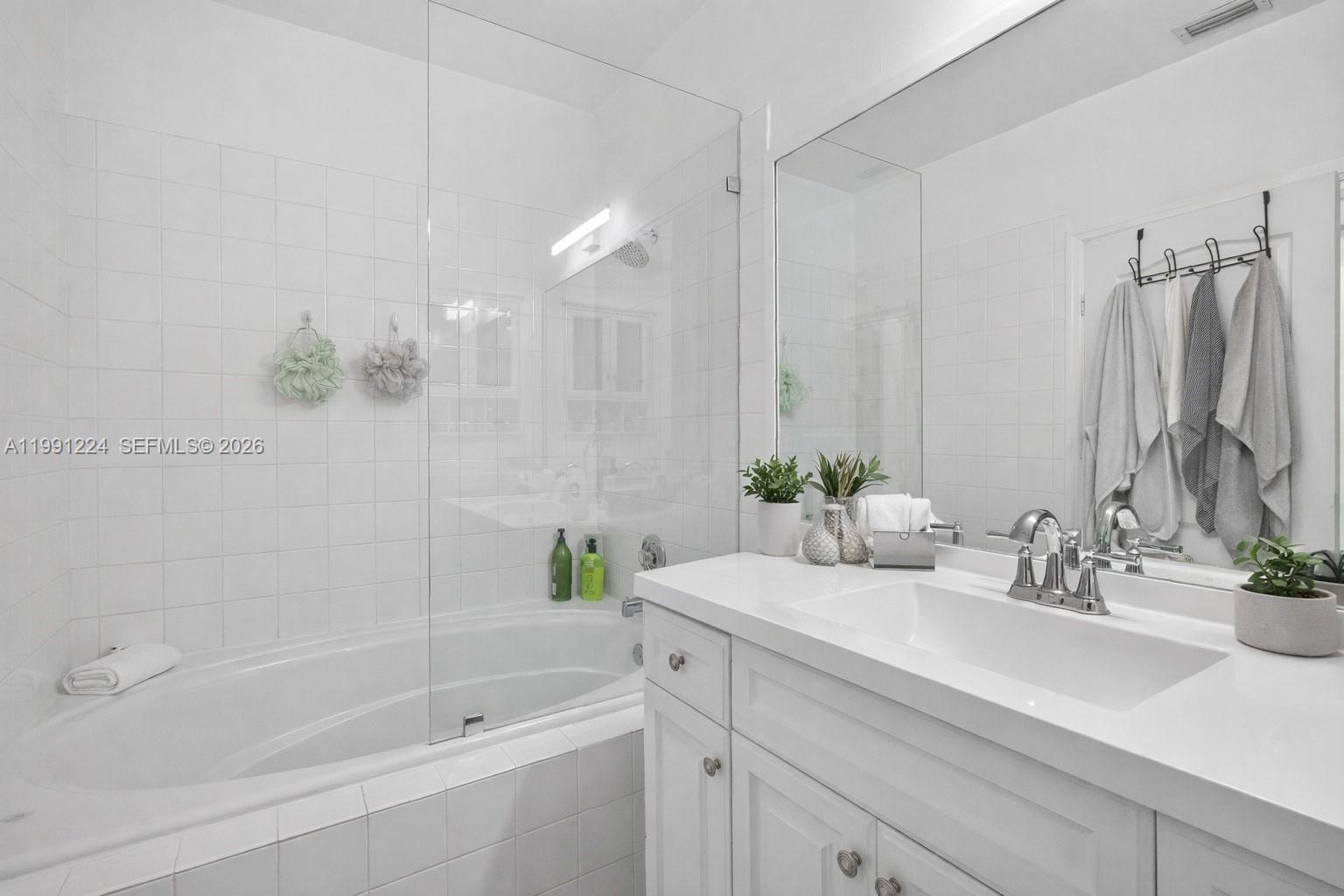 16299 Southwest 103rd Street Miami, FL 33196 - Photo 22 of 30 a bathroom with a bathtub sink and mirror