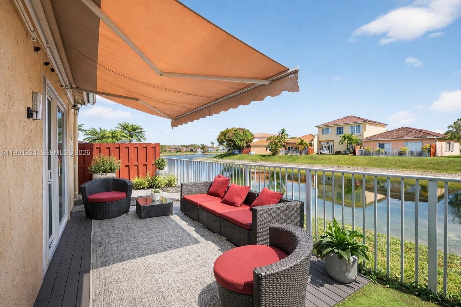 16299 Southwest 103rd Street Miami, FL 33196 - Photo 28 of 30 a balcony with hardwood filled with table and chairs