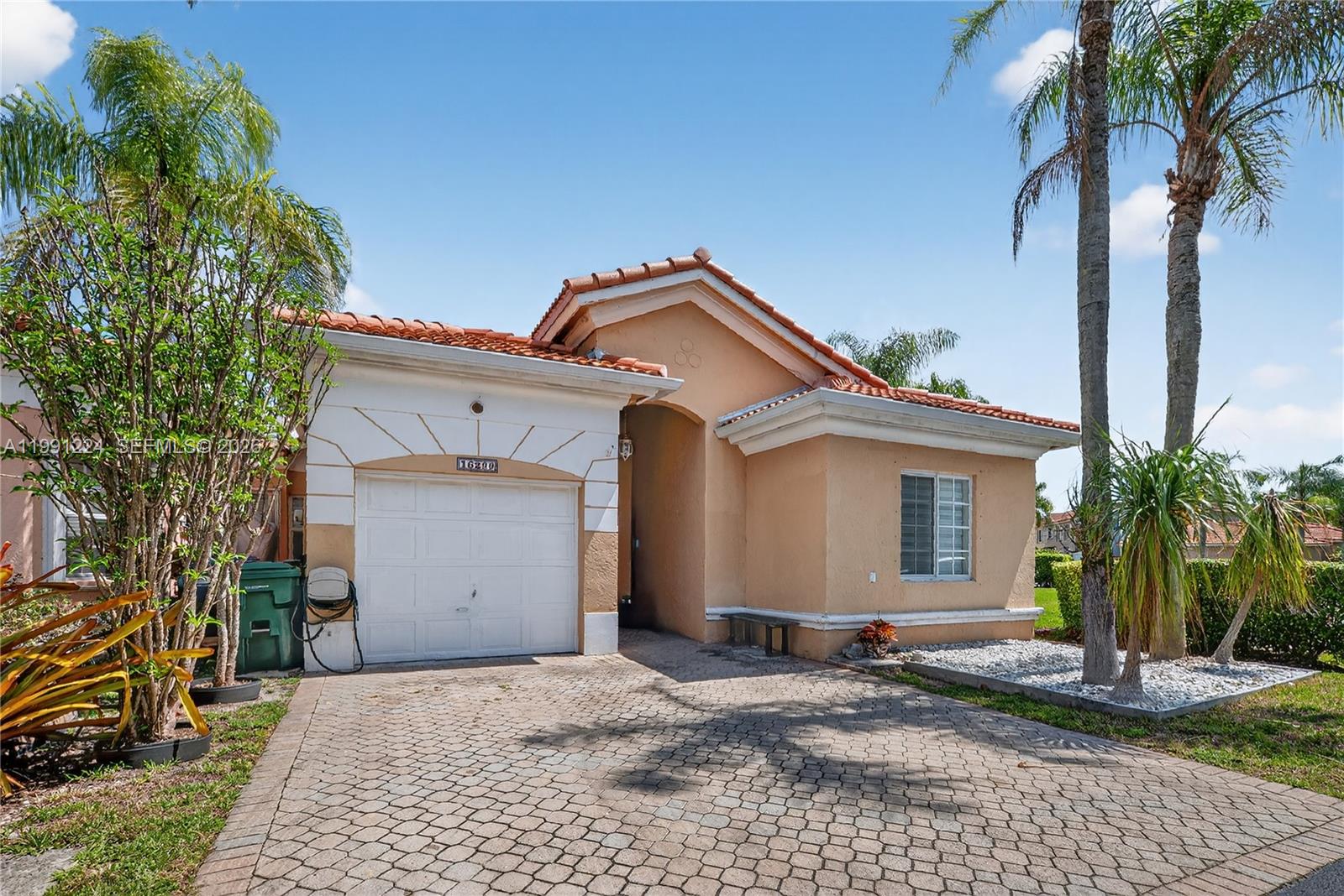16299 Southwest 103rd Street Miami, FL 33196 - Photo 3 of 30 a front view of a house with a yard