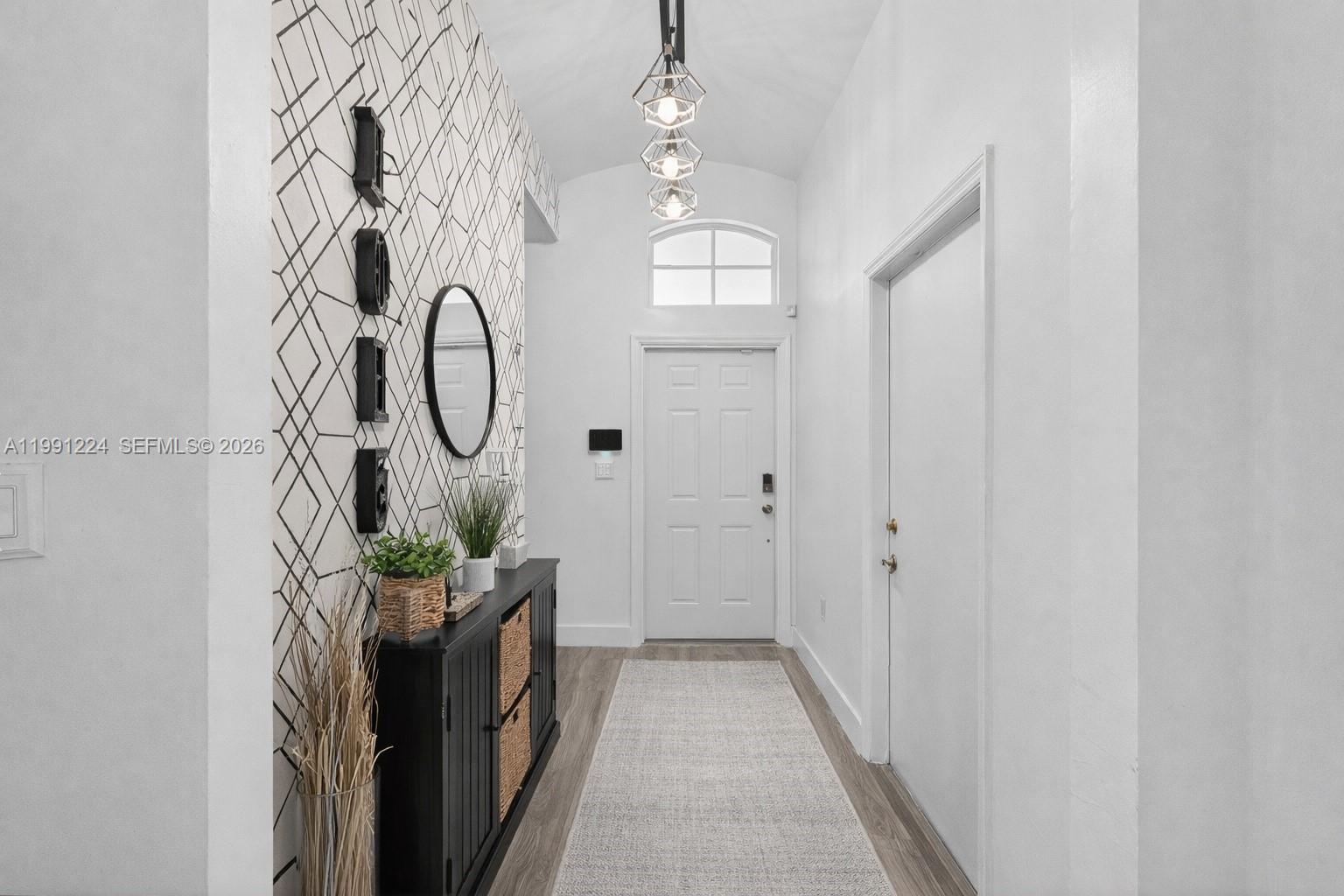 16299 Southwest 103rd Street Miami, FL 33196 - Photo 4 of 30 a very nice looking hallway with a white painted walls