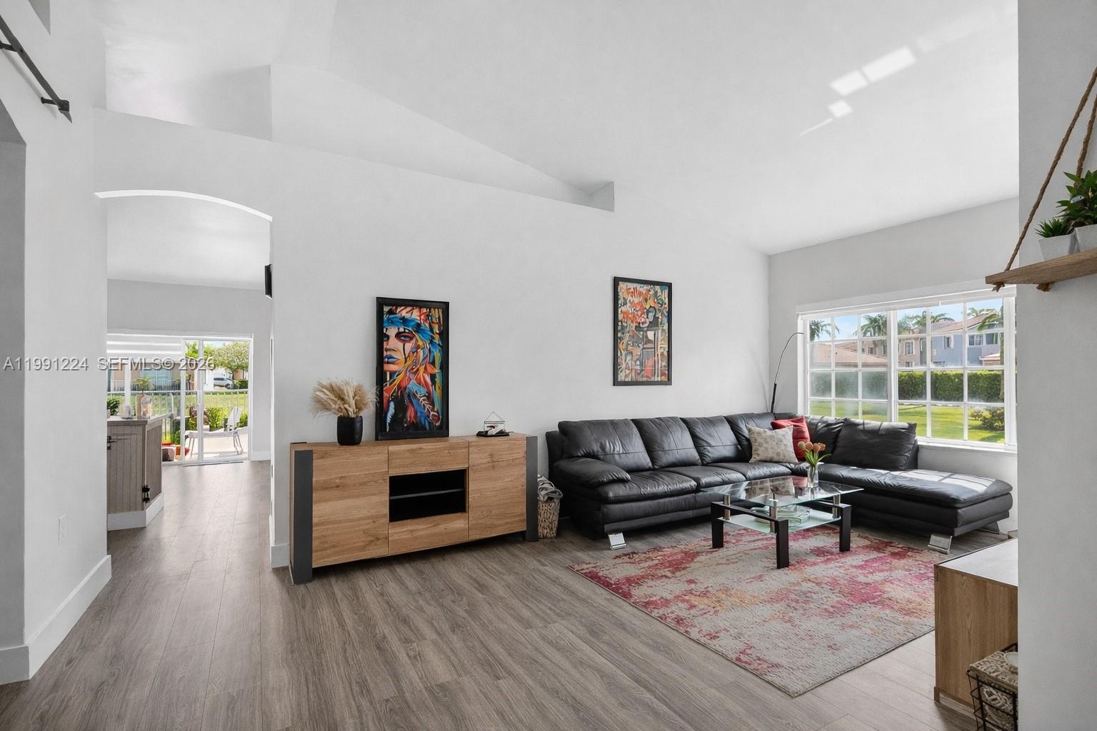 16299 Southwest 103rd Street Miami, FL 33196 - Photo 7 of 30 a living room with furniture and a wooden floor