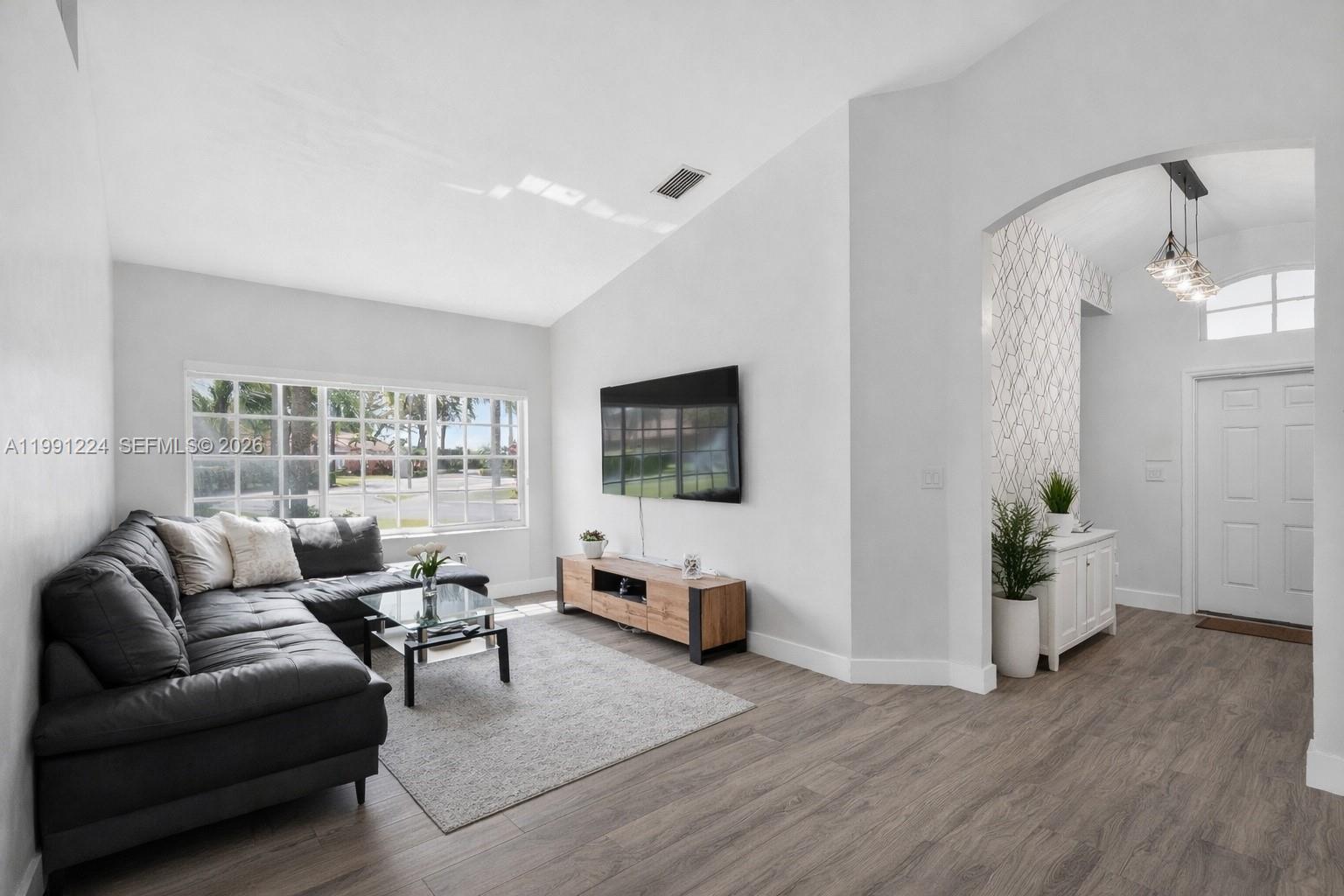 16299 Southwest 103rd Street Miami, FL 33196 - Photo 9 of 30 a living room with furniture and wooden floor