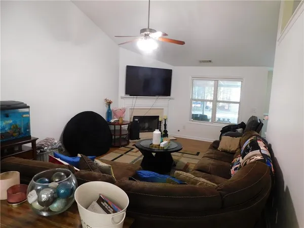 a living room with furniture and a flat screen tv