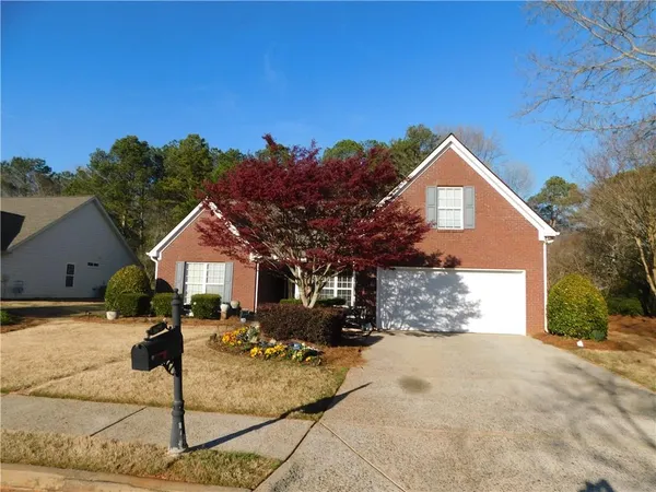 a front view of a house with a yard