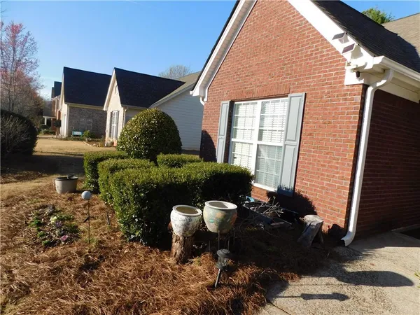 a front view of a house with garden