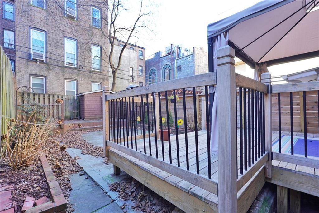 378 8th Street Brooklyn, NY 11215 - Photo 33 of 37 a view of a brick house with wooden fence