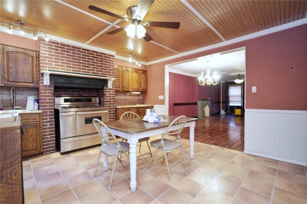 378 8th Street Brooklyn, NY 11215 - Photo 9 of 37 a kitchen with a stove a refrigerator and a microwave
