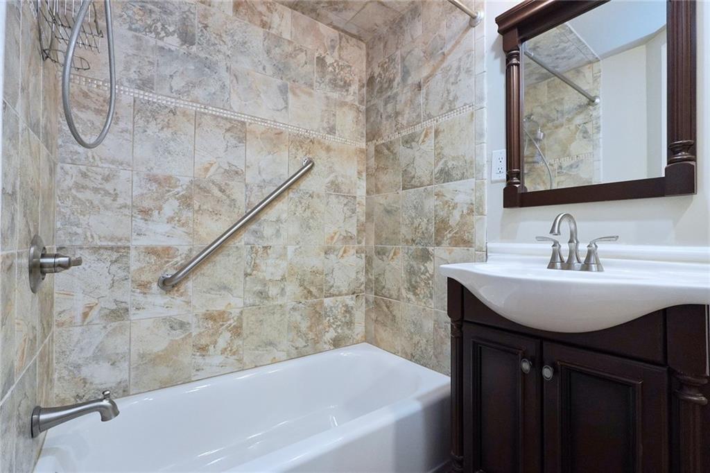 378 8th Street Brooklyn, NY 11215 - Photo 10 of 37 a bathroom with a sink vanity mirror and bathtub