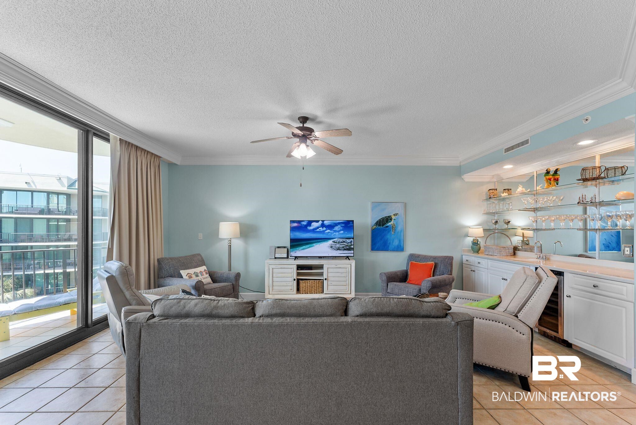 27580 Canal Road, Unit 1427 Orange Beach, AL 36561 - Photo 18 of 38 Living room featuring ornamental molding, light tile patterned floors, a ceiling fan, bar with sink, and beverage cooler