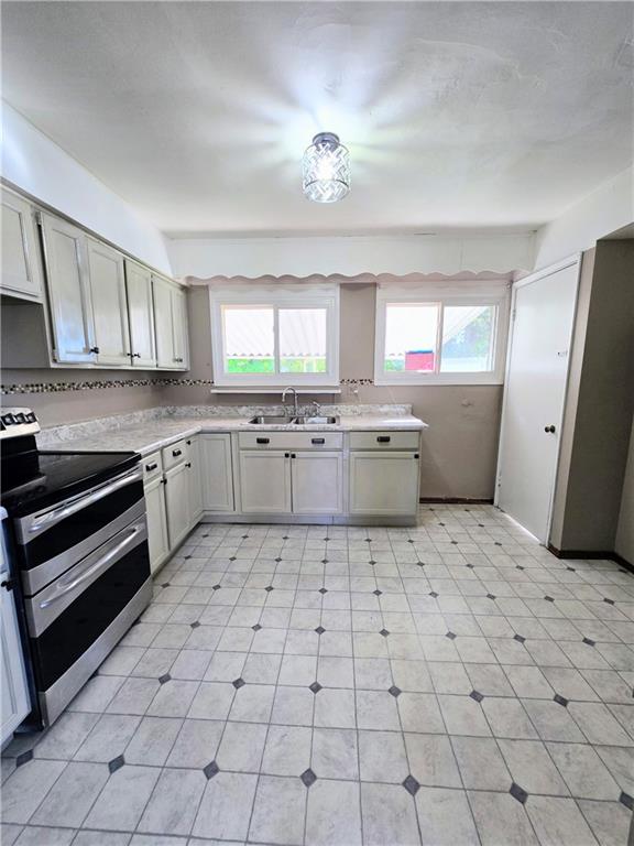 223 Emerson Avenue Farrell, PA 16121 - Photo 11 of 25 a kitchen with stainless steel appliances a sink and cabinets